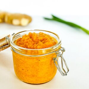 Carrot-Miso-Ginger-Dressing-in-jar-with-ginger-in-background