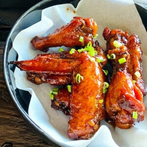 chicken-wings-on-plate-covered-in-wing-sauce