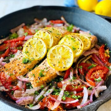 Easy-Baked-Salmon-in-skillet-lemon-in-background