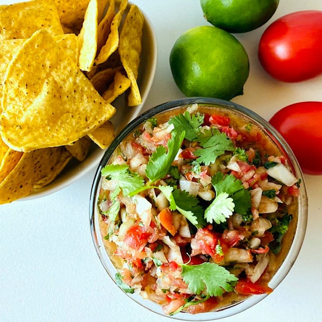 Salsa-in-bowl-with-chips-lime-and-tomato