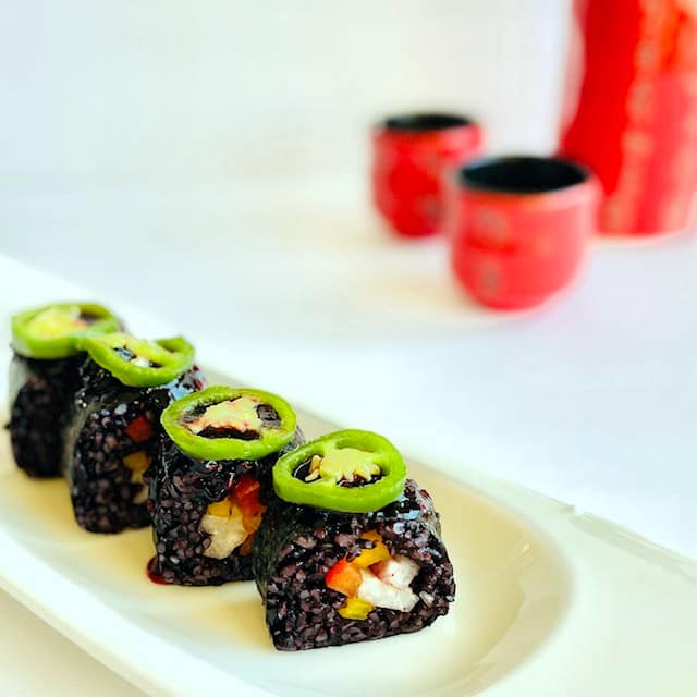 black-rice-sushi-with-sake-in-background