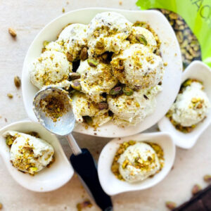 pistachio-cardamom-ice-cream-no-churn-in-bowl-with-scoop