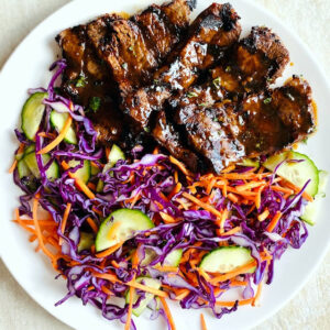 marinated-grilled-steak-on-plate-with-asian-slaw-on-side