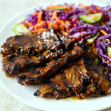 marinated-grilled-steak-on-plate-with-asian-slaw-on-side