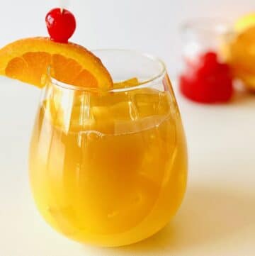 bacardi rum punch in a glass garnished with an orange slice and a cherry