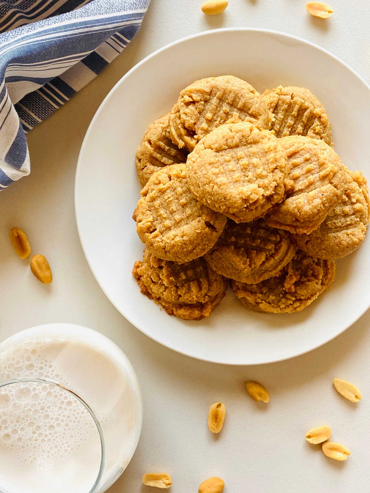 almond flour peanut butter cookies on plate next to glass of milk