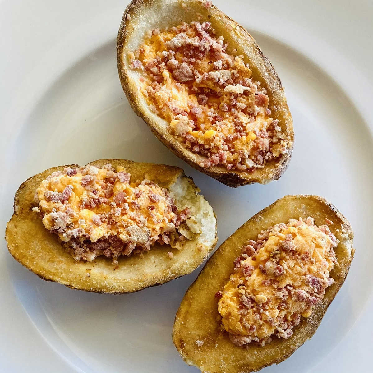 frozen potato skins on plate before cooking in air fryer