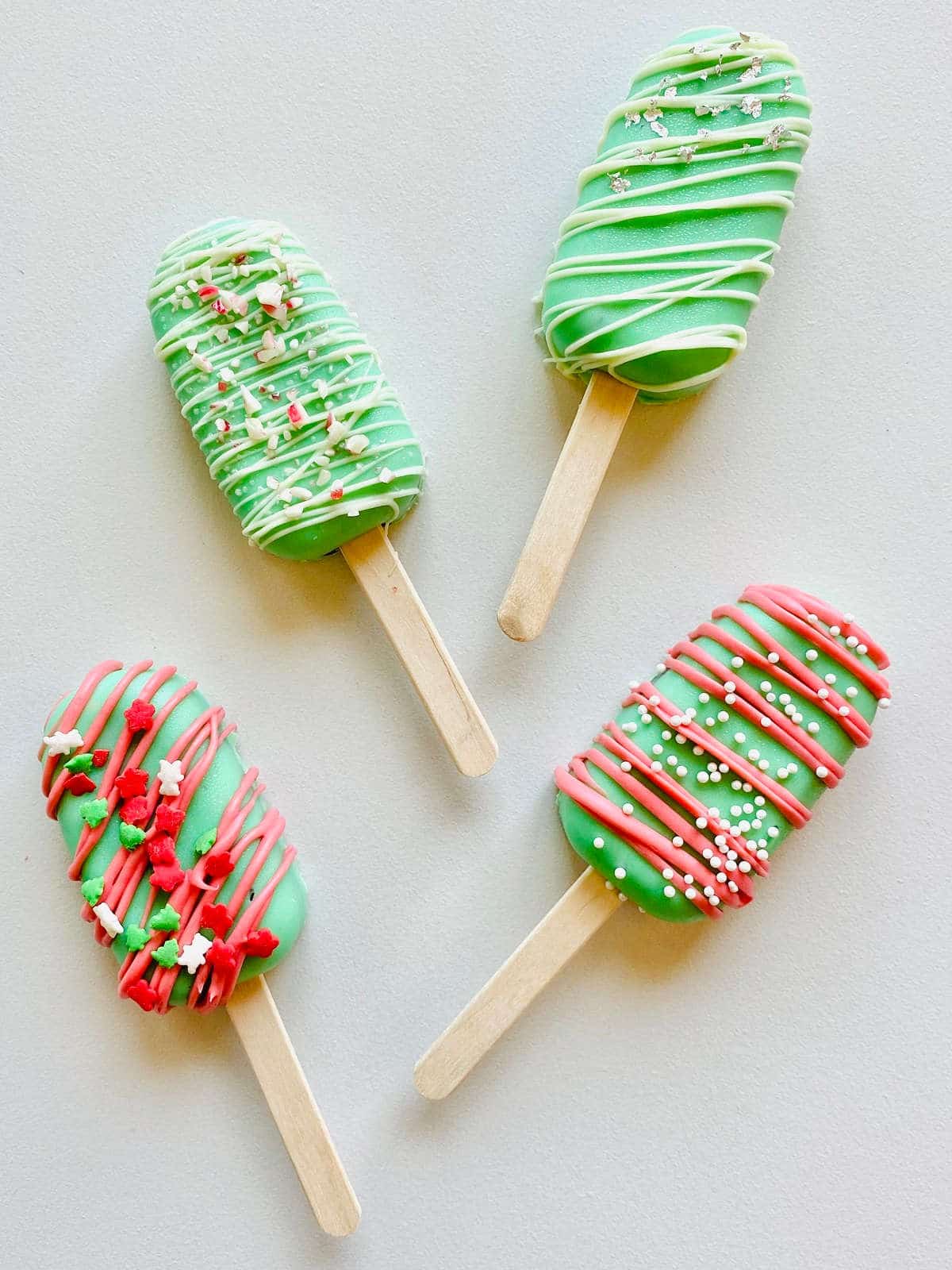 four variations of holiday cake pop popsicles