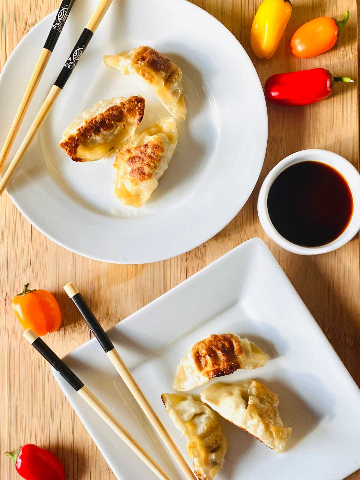 air fryer dumplings on plate with chopsticks and soy sauce