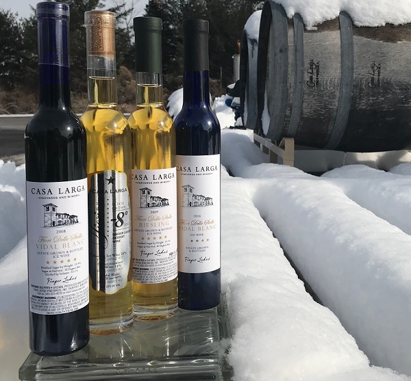 Casa Larga Ice Wine in the snow next to wine barrels