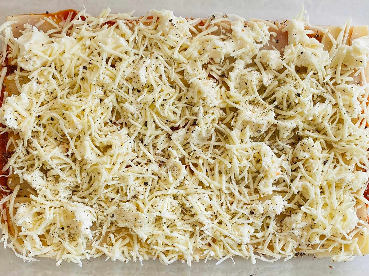 hearts of palm lasagna noodles topped with cheese before cooking in oven