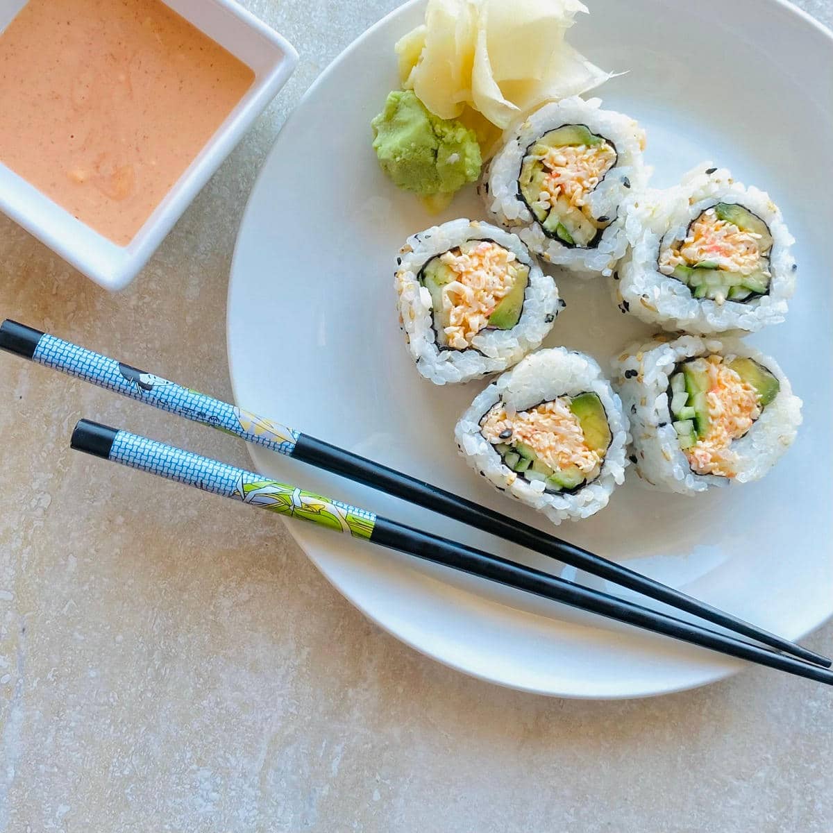 kani salad roll on a plate with chopsticks