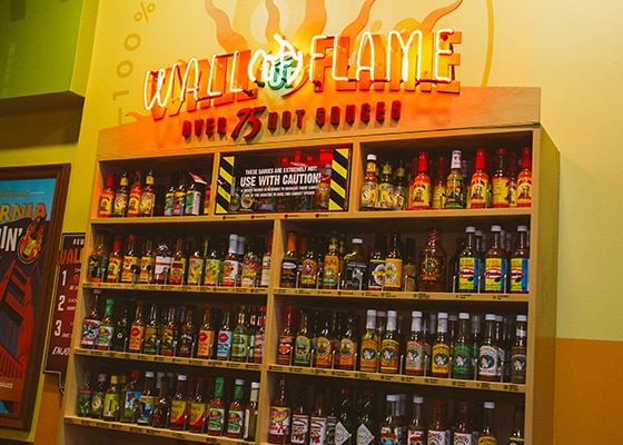 wall of flame in california with all different hot sauces