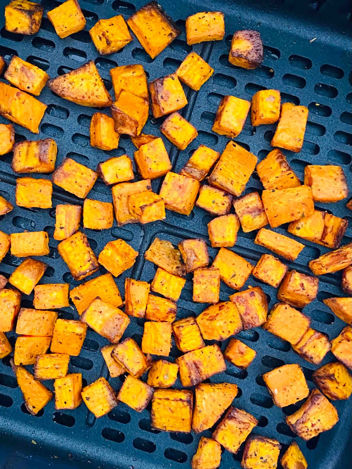 air fried sweet potato cubes in air fryer basket