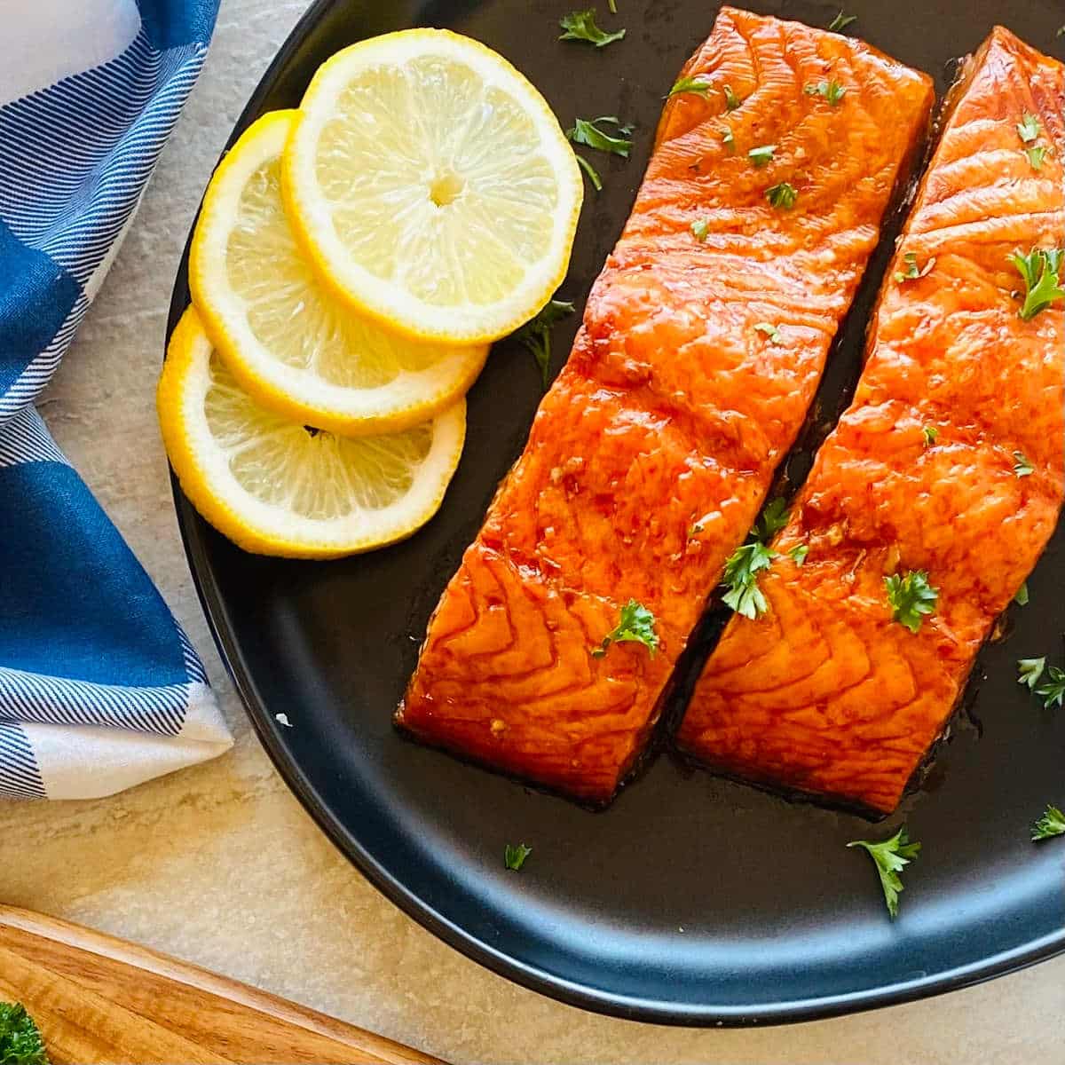 pit boss smoked salmon on a plate with sliced lemons.