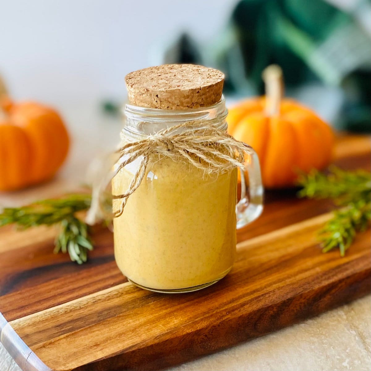 starbucks pumpkin sauce recipe in a mason jar with twine and a cork.
