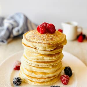 sweet cream pancake recipe on a plate with fresh berries