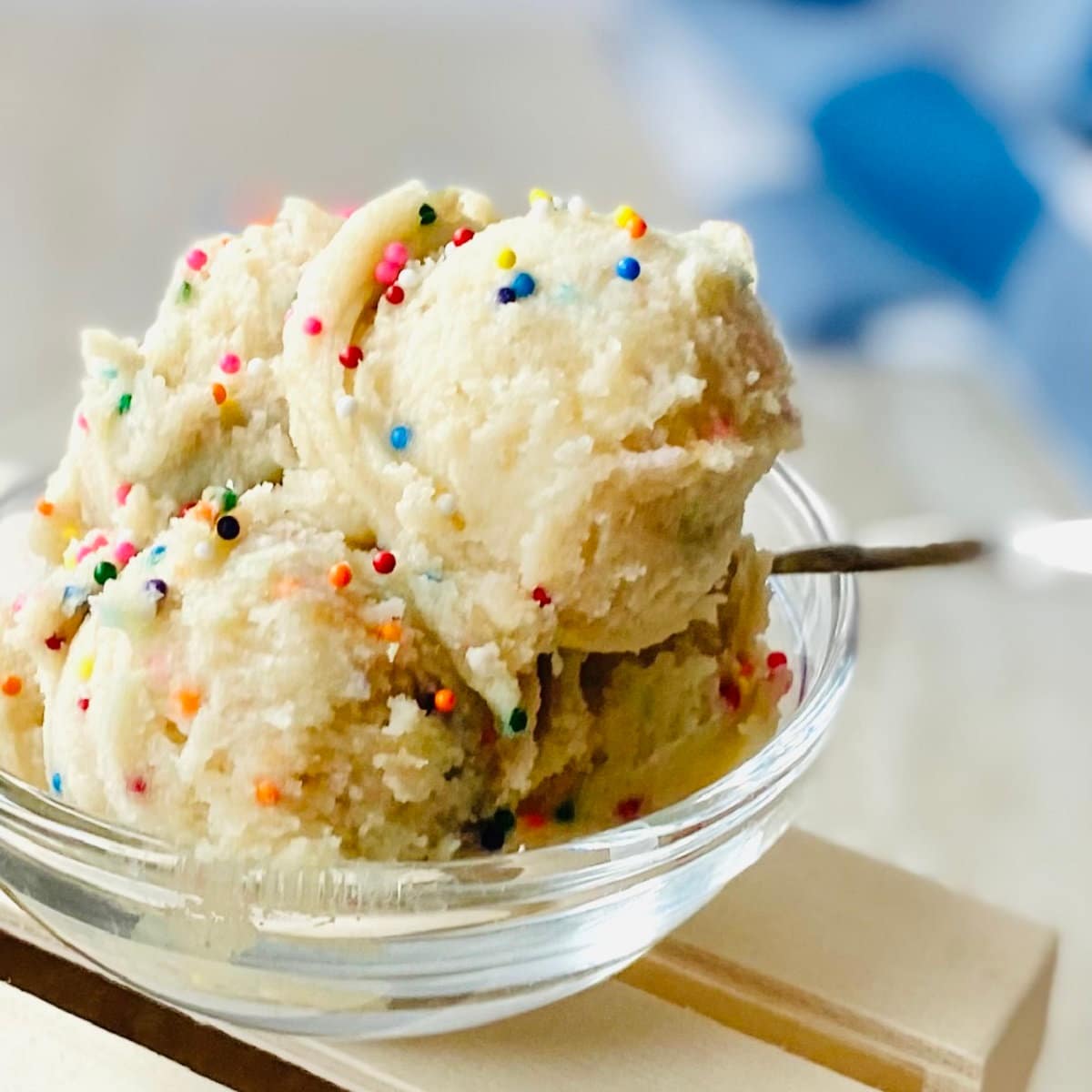 edible sugar cookie dough recipe in bowl with sprinkles and a spoon.