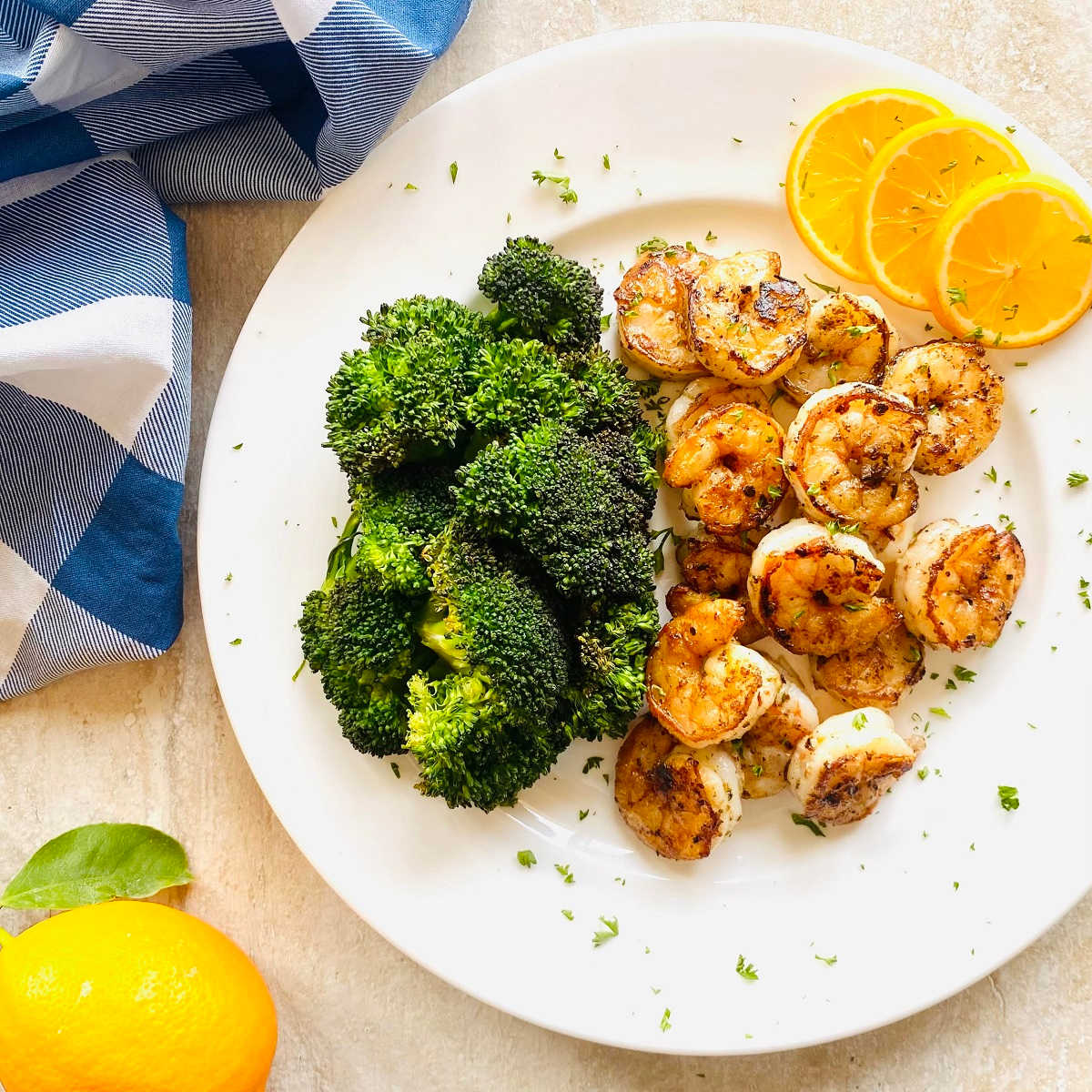 seared shrimp recipe with sides and a blue linen.