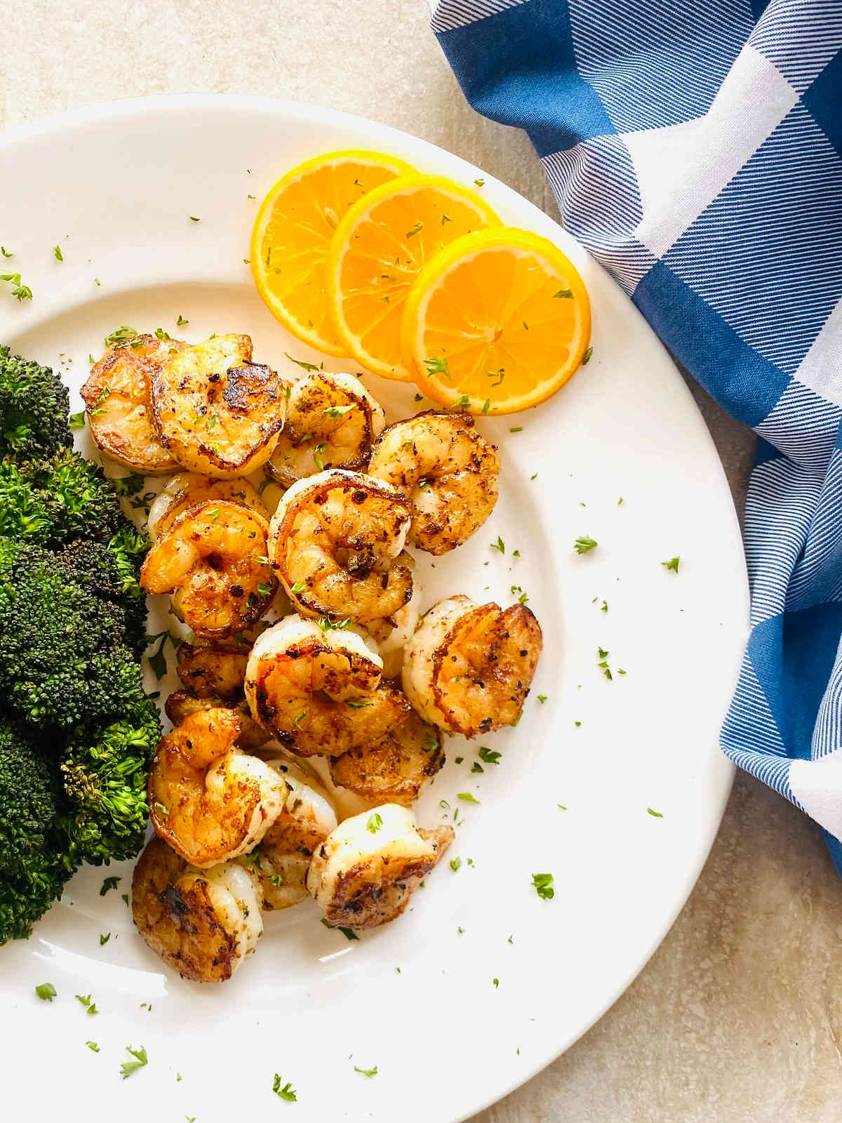 seared shrimp on plate with lemon.